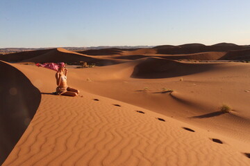Beautiful woman in the dunes of the desert