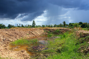 A newly dug well with a storm behind it