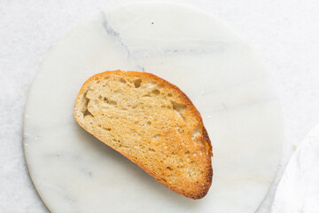Overhead view of toasted slice of artisan bread, top view of toasted slice of sandwich bread