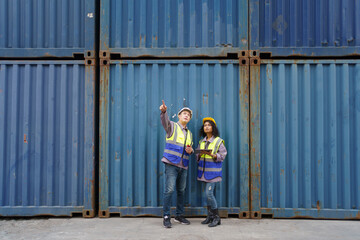 Fototapeta premium Businesswoman and logistic or shipyard engineer have a discussion or business due at container yard.
