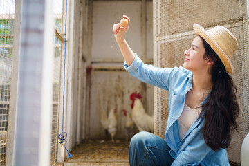 High school girl in chicken farm showing a fresh eggs to camera.