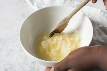 Creaming oil sugar and egg with a wooden spoon, the process of making a cake and cookies, mixing...