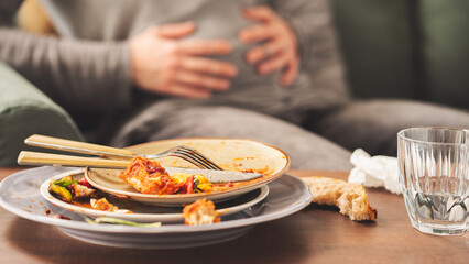 Woman with bloating and stomach pain after eating