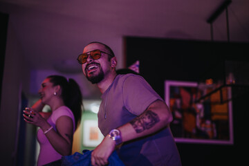 A lively indoor birthday party with friends enjoying the celebration. The joyful atmosphere is filled with laughter and happiness, creating unforgettable memories.