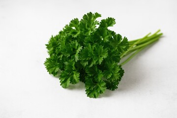 Fototapeta premium Fresh parsley spread on a white stone surface with selective focus