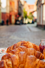 Fragrant croissant breakfast in a cozy old town on the summer terrace of an atmospheric cafe in...