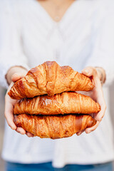 Girl holding croissants in hands bokeh appetite white background