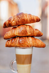 Fragrant croissant breakfast in a cozy old town on the summer terrace of an atmospheric cafe in...