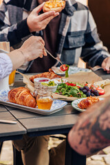 Breakfast on the summer terrace of a cafe in a European city, people, hands, action, emotions, croissant, sauce, salad, flowers, atmosphere
