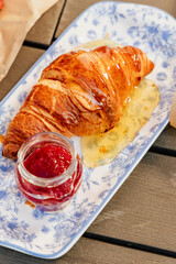 Fragrant croissant breakfast in a cozy old town on the summer terrace of an atmospheric cafe in Europe