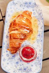 Fragrant croissant breakfast in a cozy old town on the summer terrace of an atmospheric cafe in...