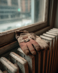 Dusty Brown Work Glove on Radiator Near Window