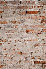 Vintage damaged brick wall texture with exposed mortar