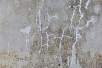 White paint drips on gray concrete wall texture