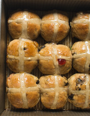 Overhead view of hot cross buns in a silver baking pan