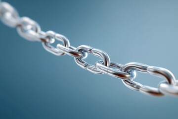 Fototapeta premium Shiny metal chain link against blue background