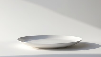 Plain white round dish on a white background