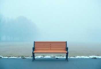 A solitary wooden park bench sits amidst a foggy landscape, facing a distant treeline, unadorned wooden park bench, horizontal slats for seating and a metal frame. The bench's color is a light brown