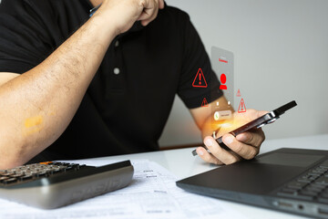 Man receiving scam call with cyber threat alert icons on smartphone screen in office environment