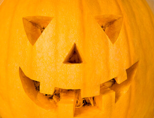 Halloween concept - close up of a Jack-O-Lantern pumpkin. Funny Jack O Lantern