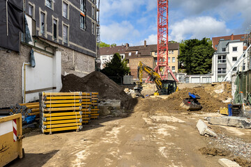 Construction site with machinery and materials in urban area