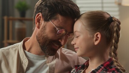 Caucasian family portrait father with daughter touching foreheads smile at home dad closeness with cute little girl adorable child kid childcare concept bonding adoption custody love in living room