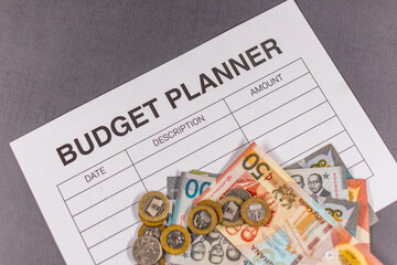 Financial planning with a budget planner and Ghanaian Cedi Currency. Concept for savings, economic literacy, and cost of living.