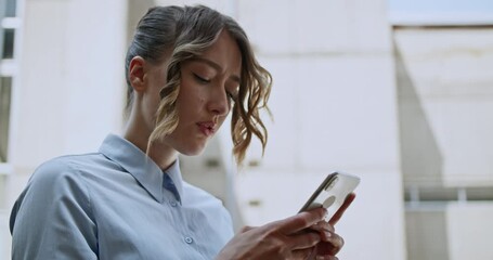 A frustrated female student engages with her smart phone, possibly grappling with challenging online coursework or educational content. Her expressions convey stress and deep concentration.