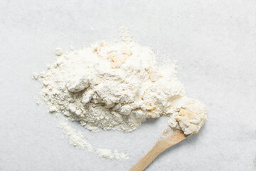 Overhead view of doughnut dough being kneaded on a white countertop, top view of doughnut dough on a white countertop