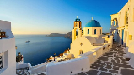 Santorini greece view of white buildings with blue domes overlooking the ocean at sunset time. Blue dome church by the sea. Sunset view from Greek island. Beautiful street in coastal town - Powered by Adobe