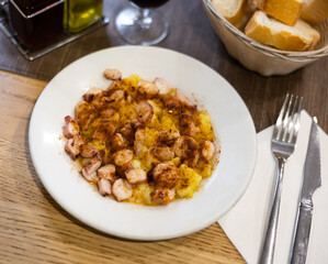 Delicious octopus galician style served with potatoes on plate