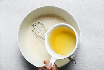 overhead view of Vegetable oil in a measuring cup, top view of vegetable oil for baking