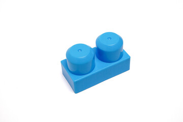 Close-up of blue toy block with two knobs used for stacking and educational play for children.