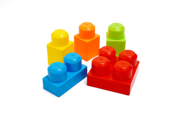 Brightly colored toy blocks arranged together on a white background, ideal for children&rsquo;s education and play concepts.
