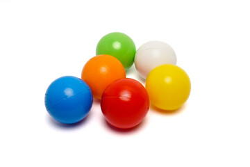 Top view of six colorful plastic balls arranged in a circle on a clean white background