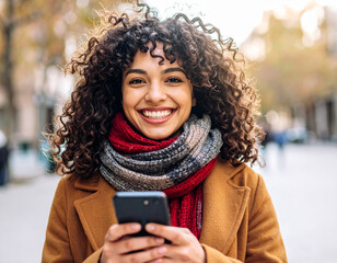 Young woman reading a message on the phone in the city
