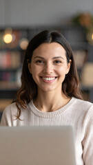 Happy young woman using laptop sitting at desk writing notes while watching webinar, studying online, looking at pc screen learning web classes or having virtual call meeting remote working from home.
