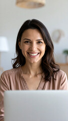 Happy young woman using laptop sitting at desk writing notes while watching webinar, studying online, looking at pc screen learning web classes or having virtual call meeting remote working from home.