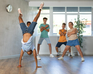 Modern dance lesson in the studio - dance on hands upside down