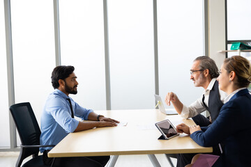 Human resources : company, successful deal. Human resources manager interviewing applicant at modern office.  Indian man candidate job interviewing and answering question hr CV recruiter