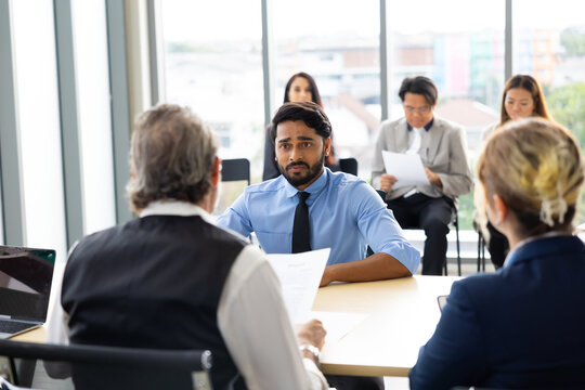 Human resources : company, successful deal. Human resources manager interviewing applicant at modern office.  Indian man candidate job interviewing and answering question hr CV recruiter