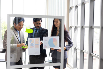 Brainstorm Mindmapping :  Diverse Professionals Brainstorming on Glass Wall with Sticky Notes. ...
