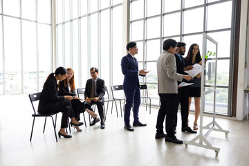 Brainstorm Mindmapping :  Diverse Professionals Brainstorming on Glass Wall with Sticky Notes. ...