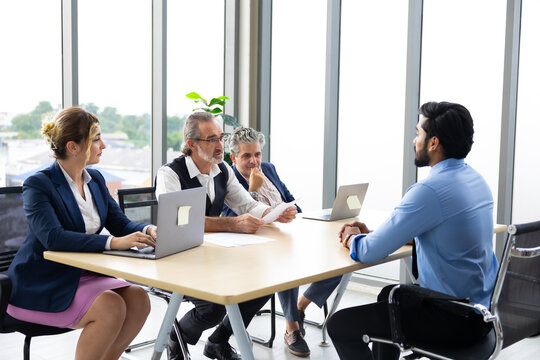 Diversity business people meetting : business teamwork diverse company people discussion at computer in meeting room. Group caucasian colleagues discussion during business meeting