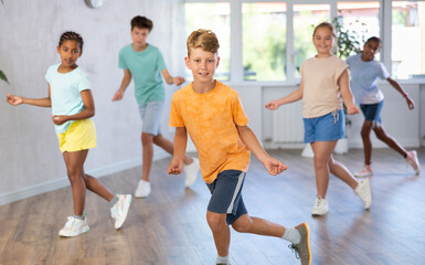 Dance studio - happy girls and boys in dance lesson
