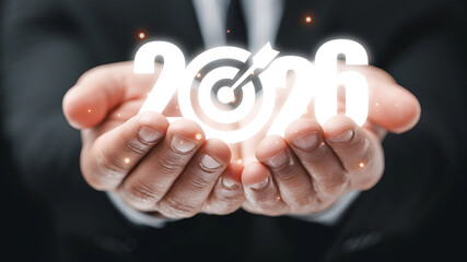 Businessman holding target in 2026 future goals and planning.