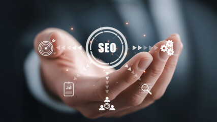 Hand holding SEO icons representing digital marketing and search optimization.