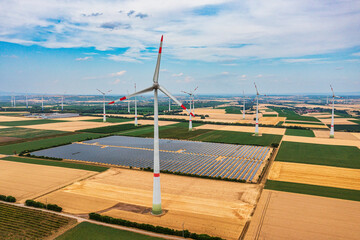 A bird's-eye view of grain fields and a wind farm with a solar field in Rheinhessen