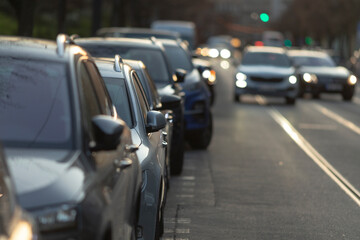 The image depicts a scene featuring numerous cars caught in a traffic jam, all waiting patiently to...