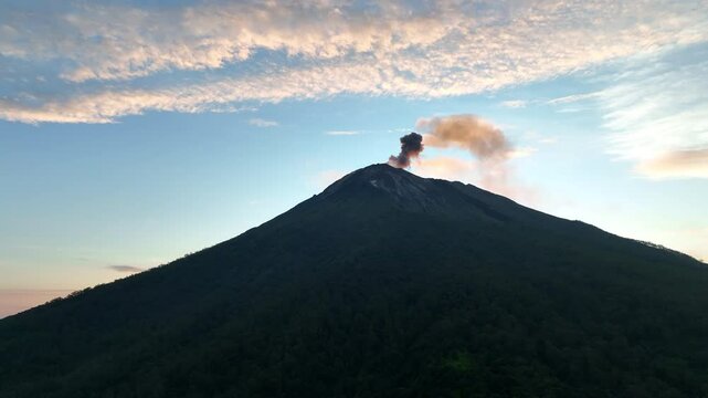 Sunset illuminates the peak of Iliape volcano on Lembata Island in the Lesser Sunda Islands of Indonesia. This scenic volcano in the ring of fire has been extremely active since 2024.